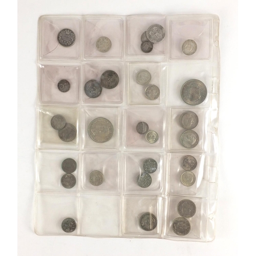 212 - Queen Anne and later predominantly British coinage, some silver housed in a folder including a 1711 ... 