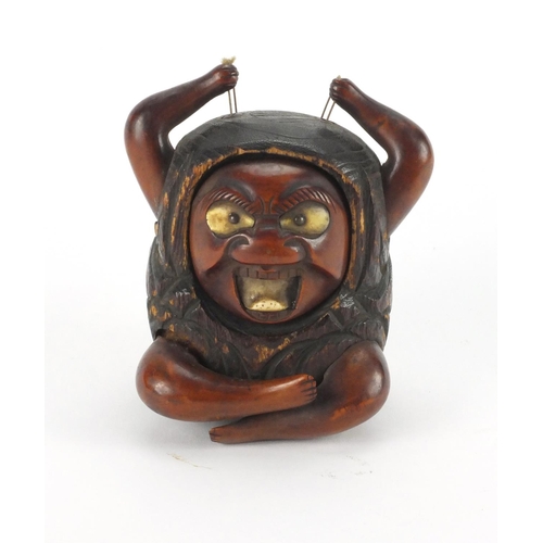 565 - Japanese wooden devil with bone eyes and tongue, inset Mother of Pearl panel with character marks to... 