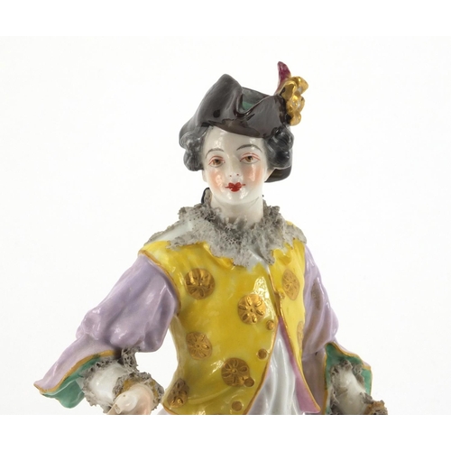 659 - Continental hand painted porcelain figure of a Dandy, blue cross sword marks to the base, 23cm high