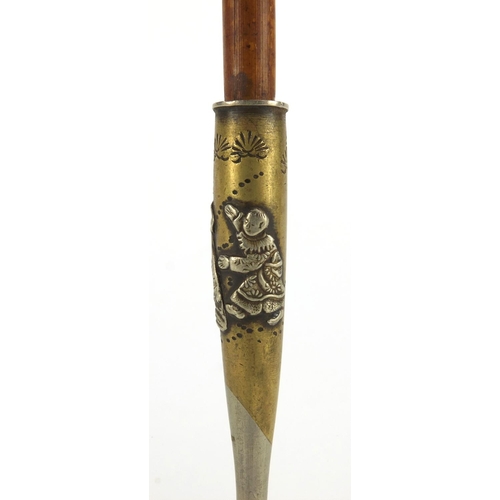 566 - Oriental silvered metal and bamboo opium pipe decorated with a figure and a mythical creature, 19.5c... 