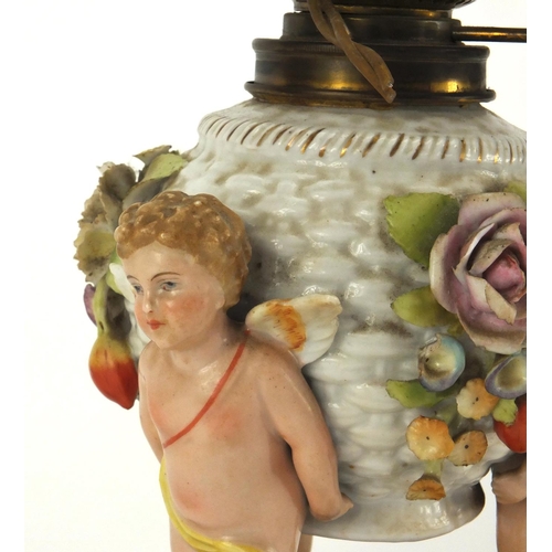 664 - Continental hand painted porcelain oil lamp base with putti supports, overall 40cm high