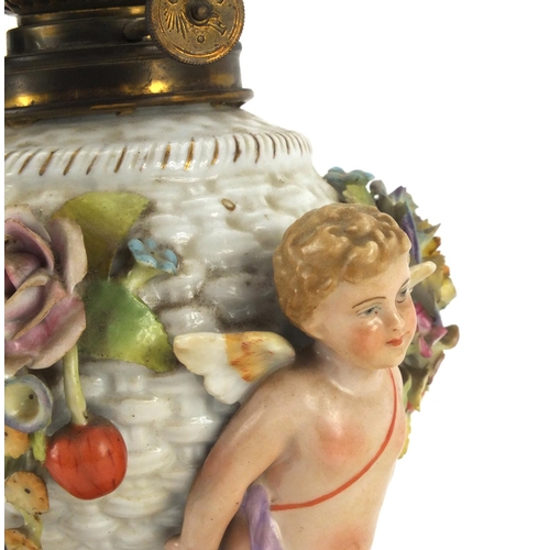 664 - Continental hand painted porcelain oil lamp base with putti supports, overall 40cm high