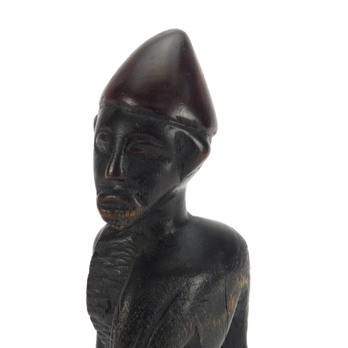 643 - Tribal interest wooden carving of a tribesman, 22cm high