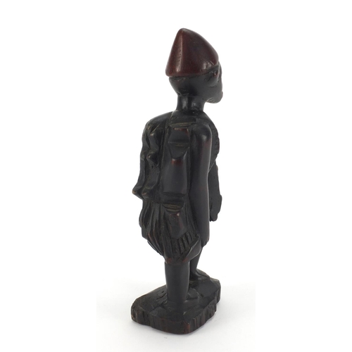 643 - Tribal interest wooden carving of a tribesman, 22cm high