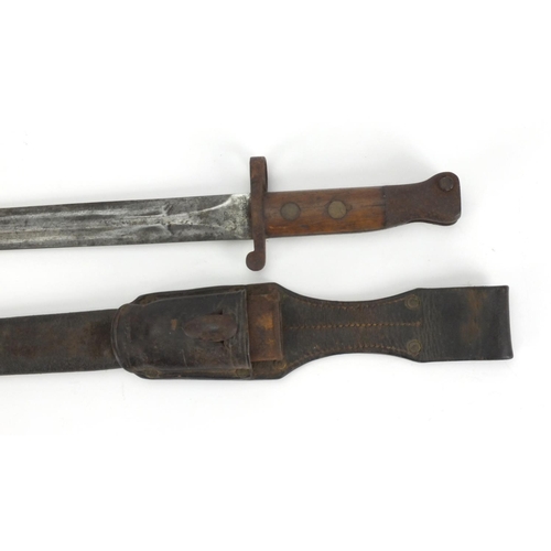 354 - Military interest bayonet with leather scabbard and frog, the bayonet with wooden grip and impressed... 