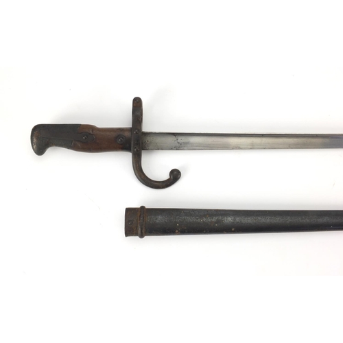 347 - 19th century French Military bayonet and scabbard with wooden grip, dated 1875 numbered 24559, engra... 