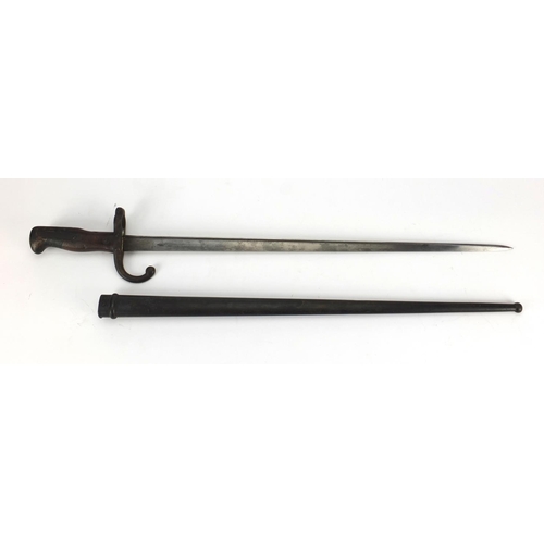 348 - 19th century French military interest St Etienne bayonet and scabbard with wooden grip, numbered 144... 