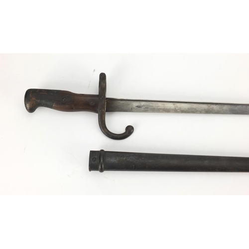 348 - 19th century French military interest St Etienne bayonet and scabbard with wooden grip, numbered 144... 