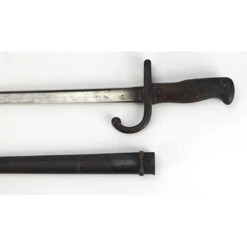 348 - 19th century French military interest St Etienne bayonet and scabbard with wooden grip, numbered 144... 