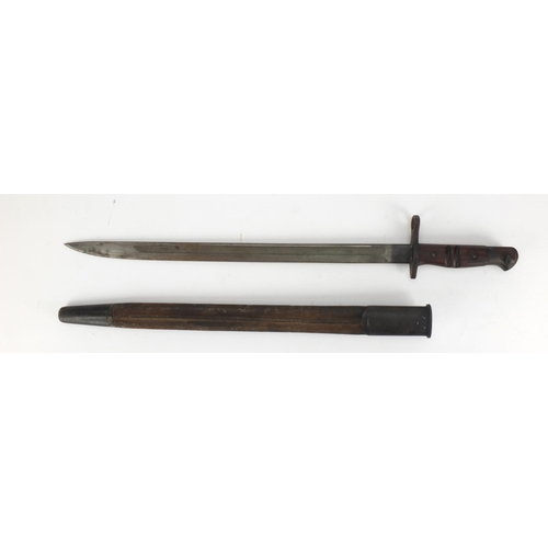 344 - British Military Remington 1913 pattern bayonet and scabbard with wooden grip, impressed marks to th... 