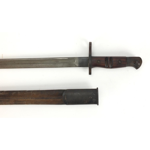 344 - British Military Remington 1913 pattern bayonet and scabbard with wooden grip, impressed marks to th... 