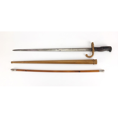 346 - 19th century French Military interest bayonet and scabbard with wooden grip, dated 1877, together wi... 