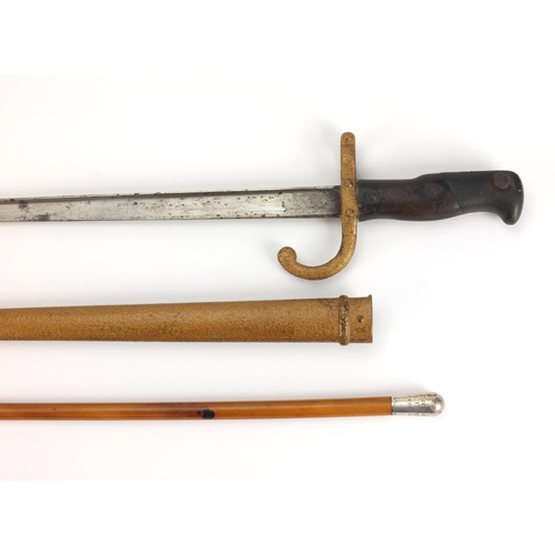 346 - 19th century French Military interest bayonet and scabbard with wooden grip, dated 1877, together wi... 