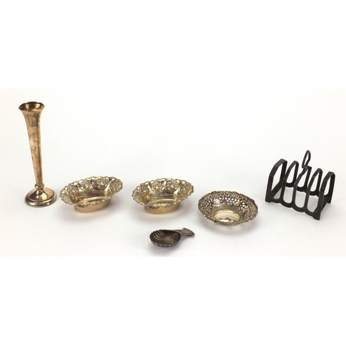 826 - Silver items comprising four slice toast rack, pair of dishes embossed with flowers, circular dish w... 