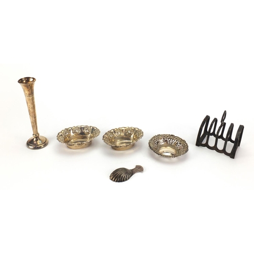 826 - Silver items comprising four slice toast rack, pair of dishes embossed with flowers, circular dish w... 