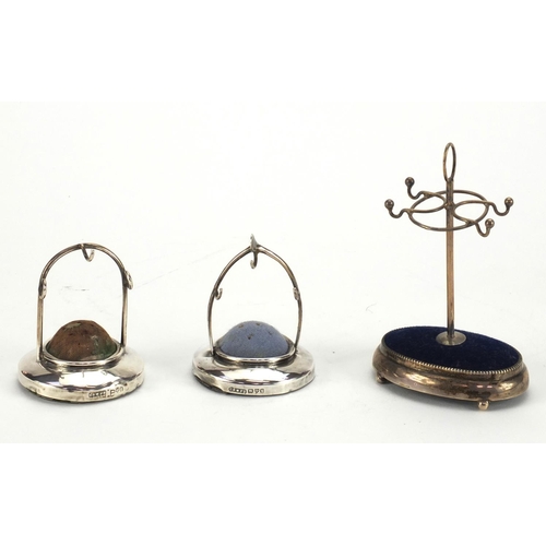 16 - Three silver hat pin and ring stands, various hallmarks, the largest 11cm high