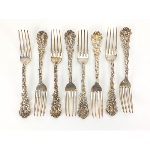 871 - Set of eight sterling silver forks, the terminals decorated with a figure in a wolf head dress and c... 