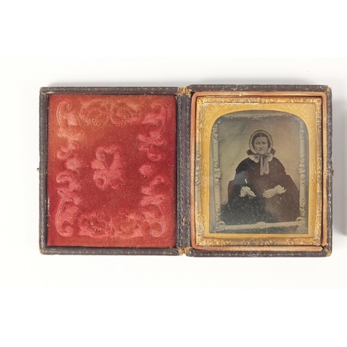 134 - Three Victorian black and white photographs each with gilt metal mounts, two housed in tooled leathe... 