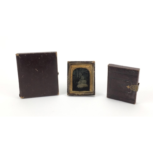 134 - Three Victorian black and white photographs each with gilt metal mounts, two housed in tooled leathe... 