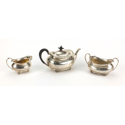 805 - Silver three piece tea service, the teapot with ebonised wood handle and knop, H.A Sheffield 1909, t... 