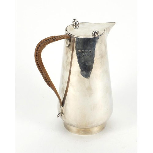 806 - Mappin & Webb silver water jug in the style of Christopher dresser, Birmingham 1919, 19cm high, appr... 