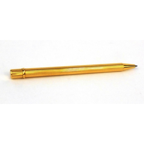 93 - Cartier gold plated ballpoint pen with two refills, the pen numbered 486556