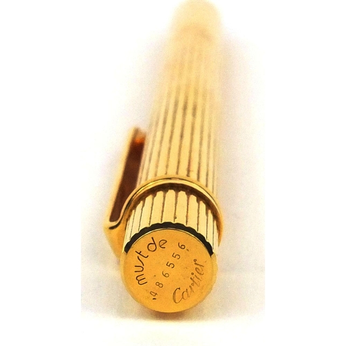 93 - Cartier gold plated ballpoint pen with two refills, the pen numbered 486556