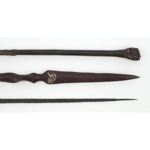 645 - Tribal interest wooden staff carved with a clenched fist pommel, woodens pear and a metal spear head... 