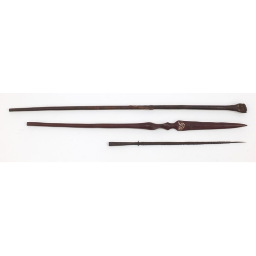 645 - Tribal interest wooden staff carved with a clenched fist pommel, woodens pear and a metal spear head... 