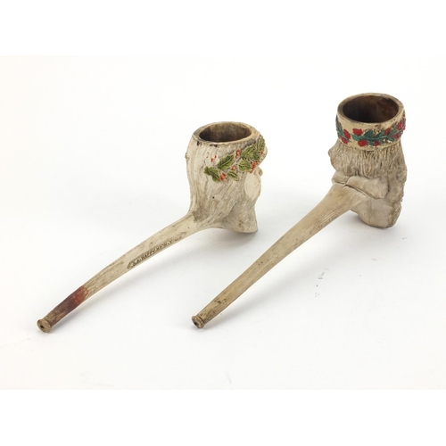 84 - Two clay pipes one of Father Christmas, the other inscribed A Merry Christmas and A Happy New Year, ... 