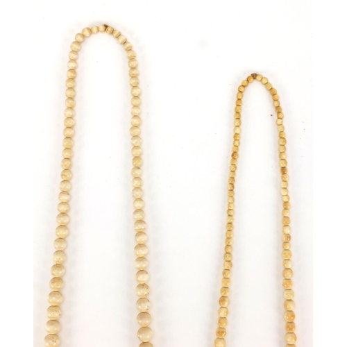 551 - Two Chinese ivory graduated bead necklaces, together with a Mother of Pearl example, the largest bea... 