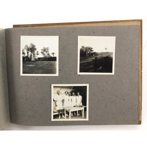 320 - Military interest black and white photographs housed in an album, including Ruins of planes, village... 