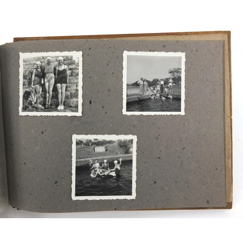 320 - Military interest black and white photographs housed in an album, including Ruins of planes, village... 