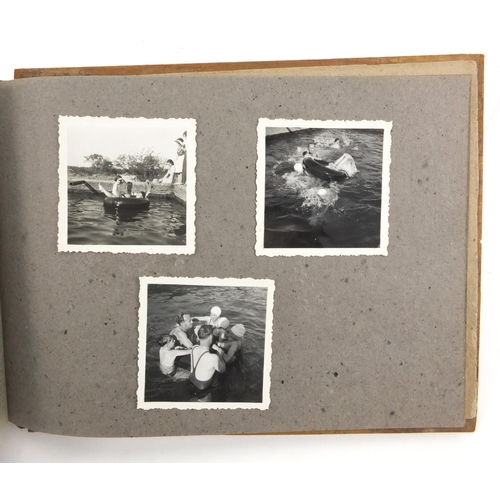 320 - Military interest black and white photographs housed in an album, including Ruins of planes, village... 