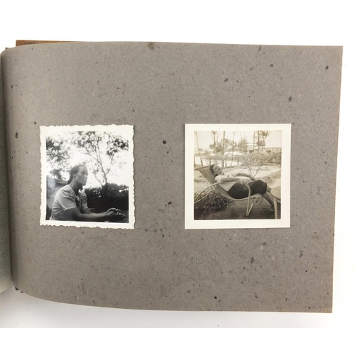 320 - Military interest black and white photographs housed in an album, including Ruins of planes, village... 