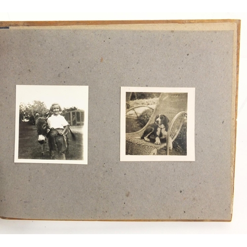 320 - Military interest black and white photographs housed in an album, including Ruins of planes, village... 