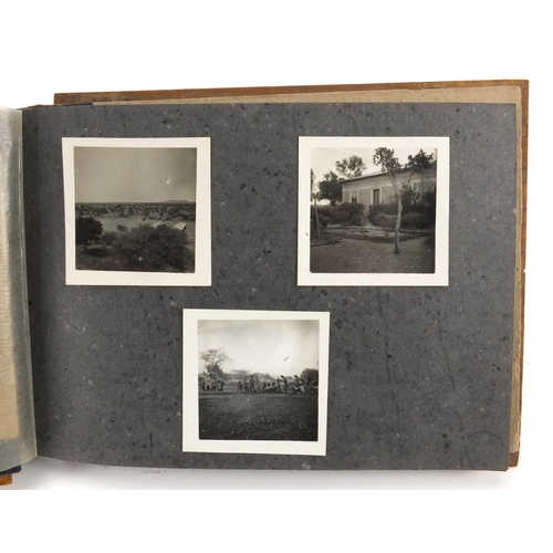 320 - Military interest black and white photographs housed in an album, including Ruins of planes, village... 