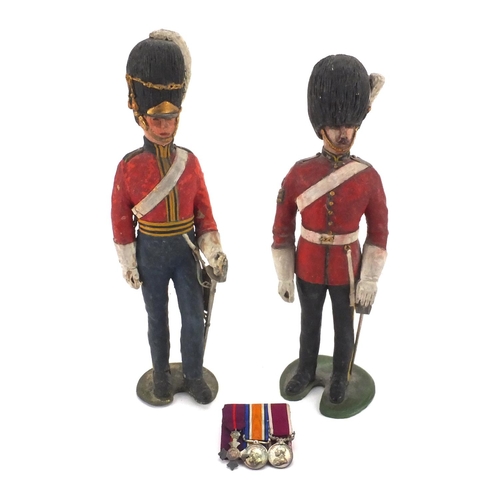 328 - British Military miniature medals together with two hand painted wooden soldiers in uniform, the min... 