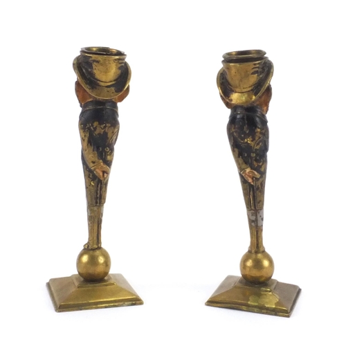 63 - Pair of 19th century brass caricature candlesticks, both inscribed Hausse, the largest 17cm high