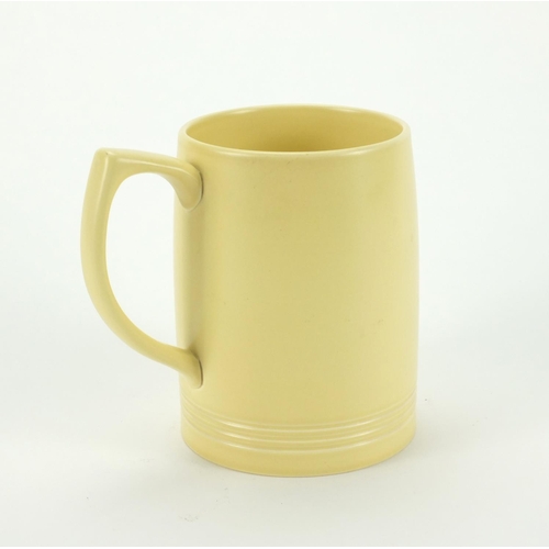 2230 - Wedgwood matt straw mug by Keith Murray, factory marks to the base, 12cm high