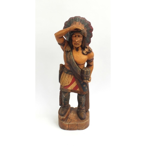 2104 - Floor standing wooden carving of an Indian Warrior, 95cm high