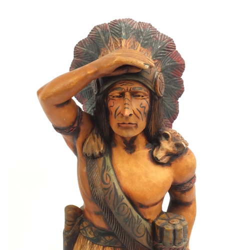 2104 - Floor standing wooden carving of an Indian Warrior, 95cm high