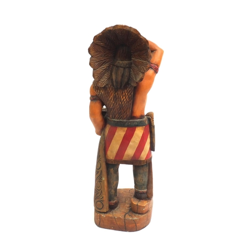 2104 - Floor standing wooden carving of an Indian Warrior, 95cm high