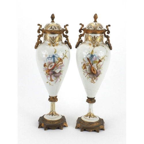 651 - Pair of 19th century Sevres urns and covers, hand painted and gilded with flowers and figures, initi... 