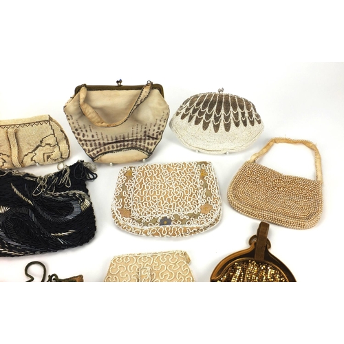 21 - Twelve predominantly beadwork clutch bag and purses, together with a embroidered miser's purse and a... 