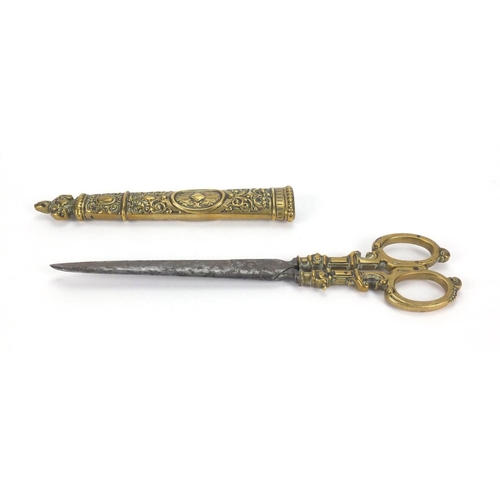 65 - Pair of 19th century brass seamstress scissors with brass sheath, embossed with floral motifs, 26.5c... 