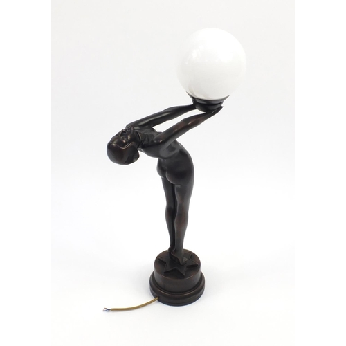 2155 - Bronzed desk lamp modelled with a nude Art Deco lady holding a white opaque globular shade, 71cm hig... 