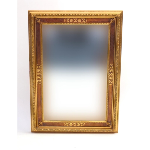 2048 - Rectangular gilt framed bevel edged mirror with floral motifs, overall 84cm x 60cm