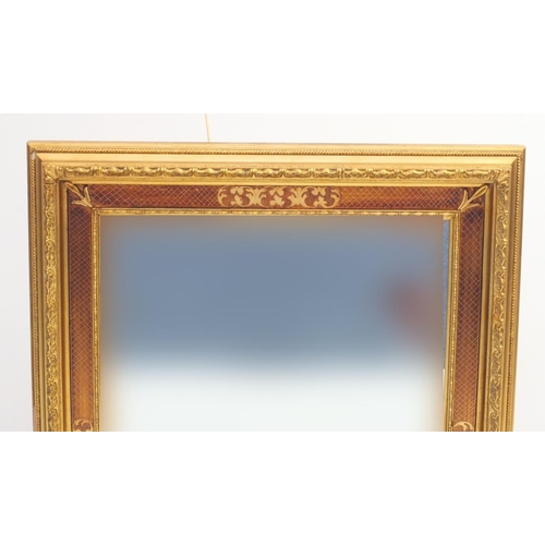 2048 - Rectangular gilt framed bevel edged mirror with floral motifs, overall 84cm x 60cm