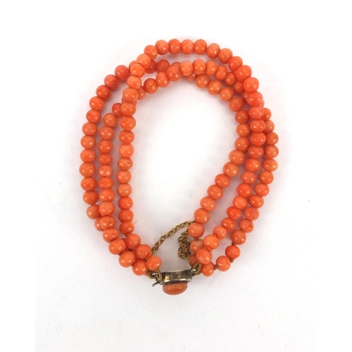 926 - Three row coral necklace and matching bracelet, the necklace 44cm long, approximate weight 59.5g